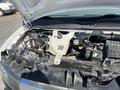 Engine compartment of a 2016 GMC Savana showing various components including the coolant reservoir battery and engine parts