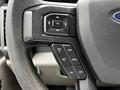 Close-up of the steering wheel controls of a 2020 Ford F-350 SD featuring buttons for cruise control and settings