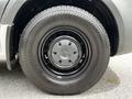 Close-up of a 2023 Mercedes-Benz Sprinter wheel showing a black tire with a smooth surface and a metallic hubcap featuring the Mercedes-Benz logo