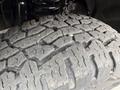 Close-up of a worn tire tread from a 2015 Ford F-350 SD showing deep grooves and rugged texture
