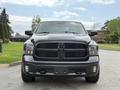 A 2018 RAM 1500 truck is shown from the front with a black grille and prominent RAM logo surrounded by sleek headlights and a rugged appearance