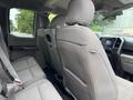 Interior of a 2018 Ford F-150 showing the back seat with gray fabric upholstery and seatbelts attached
