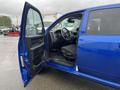 A blue 2019 RAM 1500 Classic with an open door revealing the interior featuring a steering wheel and front seats
