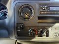 Dashboard controls of a 2021 Ford E-450 featuring air conditioning and fan settings