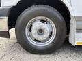 A close-up view of the wheel and tire of a 2020 Chevrolet Express showing a silver steel rim and a Bridgestone tire