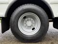A close-up of the wheel of a 2016 International CE300 featuring a silver rim and a Michelin tire with a detailed tread pattern