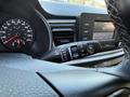 The interior dashboard of a 2018 Kia Rio5 showing the speedometer and control knobs for the windshield wipers and media settings