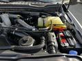 Engine compartment of a 2021 Ford F-550 showcasing components like the battery coolant reservoir and various hoses and pipes