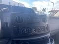 Dashboard of a 2009 Ford Econoline featuring audio controls and climate knobs
