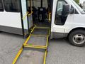 A 2017 Chevrolet Express van with an extended ramp lowered for accessibility