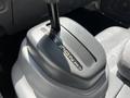 Gear shifter of a 2007 GMC W3500 showcasing the different drive modes labeled on the top of the shifter