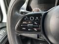 Close-up of the steering wheel controls of a 2019 Mercedes-Benz Sprinter featuring buttons for cruise control settings and functionality