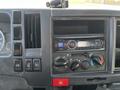 Interior dashboard of a 2017 Isuzu NQR showing gauges buttons and a car stereo system with a digital display