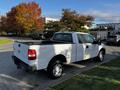 A 2008 Ford F-150 XL in white with a standard cab and a bed liner parked on a driveway