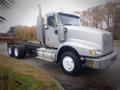 A silver 2013 International 5900i truck with a large front grille and dual exhaust pipes mounted on the sides