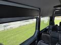 Interior view of a 2019 Mercedes-Benz Sprinter featuring seating and large windows displaying a view outside