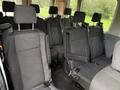 Interior view of a 2019 Ford Transit showing multiple black fabric seats arranged in rows with adjustable headrests