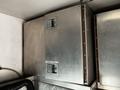 Silver metal storage box mounted inside a vehicle with a latch on the front and a smooth surface