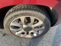 Close-up of a silver multi-spoke alloy wheel on a 2015 Fiat 500L with a Cooper tire visible on the tire sidewall