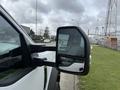 A 2021 Ford F600 truck with a close-up view of its side mirror and door handle