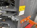 A close-up view of a control knob and warning labels on a 2018 Doosan DL300-5 machinery panel