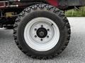 Close-up of a tire from a 2012 Toro Groundsmaster showing a rugged tread pattern and a white rim