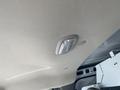 A dome light mounted on the ceiling of a 2012 GMC Savana van