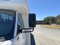 White 2020 Chevrolet Express van showing the side mirror and part of the driver's window