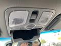 Interior overhead console of a 2015 Kia Sorento featuring lights and a storage compartment with buttons for room and door functions