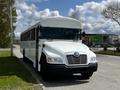 A white 2022 Blue Bird BB Conventional bus with a prominent front grille and large windows designed for passenger transport