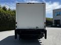 A 2018 Hino 195 truck viewed from the rear with a large white cargo box and dual rear doors