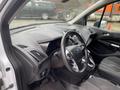 Interior of a 2017 Ford Transit Connect showing the steering wheel dashboard and controls