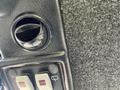 Close-up of the dashboard panel of a 2010 Kubota F3990 showing a circular vent and two control switches