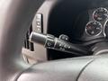 Close-up of the gear shift and control panel in a 2020 Chevrolet Express showing indicators and wiper controls