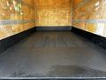 Interior view of a 2015 Hino 195 cargo area with a wooden floor and metal railings along the sides