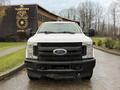 A white 2017 Ford F-350 Super Duty pickup truck is parked with its front facing the camera showing its wide grille and headlights