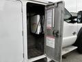 A 2016 Ford F-550 with an open service door revealing equipment inside