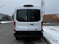 A 2021 Ford Transit van viewed from the rear with a white exterior and a black bumper