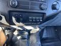Close-up of a 2016 Ford F-250 SD dashboard control panel showing radio controls and auxiliary switches