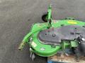 A green 2014 John Deere 1585 Terrain Cut mower attachment with a black cutting deck and a metal arm for attachment to a vehicle