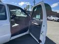 A white 2013 Ford F-250 SD with an open driver's door revealing the interior and dashboard