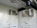 Metal brackets mounted inside a vehicle compartment designed to hold equipment securely