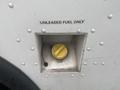 A yellow fuel cap is visible in a rectangular opening labeled with "UNLEADED FUEL ONLY" on the side of a white vehicle