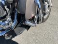 A 2004 Harley-Davidson Flhtcui motorcycle with chrome details and a visible exhaust pipe in the foreground