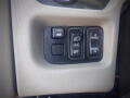 Control panel with buttons for mirror adjustment, light control, and panel illumination in a 2016 International WorkStar 7500