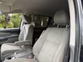 Interior view of a 2014 Honda Odyssey showing two gray fabric front seats with armrests and a center console in between