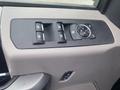 Close-up of the control panel on the driver's side of a 2017 Ford F-550 featuring window and mirror adjustment controls