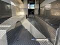 Interior view of a 2017 Freightliner M Line with metallic diamond plate flooring and benches along the sides