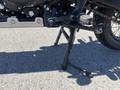 A 2022 Royal Enfield Himalayan motorcycle side stand in an upright position with a visible footpeg and drive chain