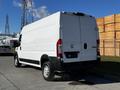 A 2019 RAM Promaster van in white with a high roof and rear doors visible from the back angle showcasing its cargo space and rear wheel design